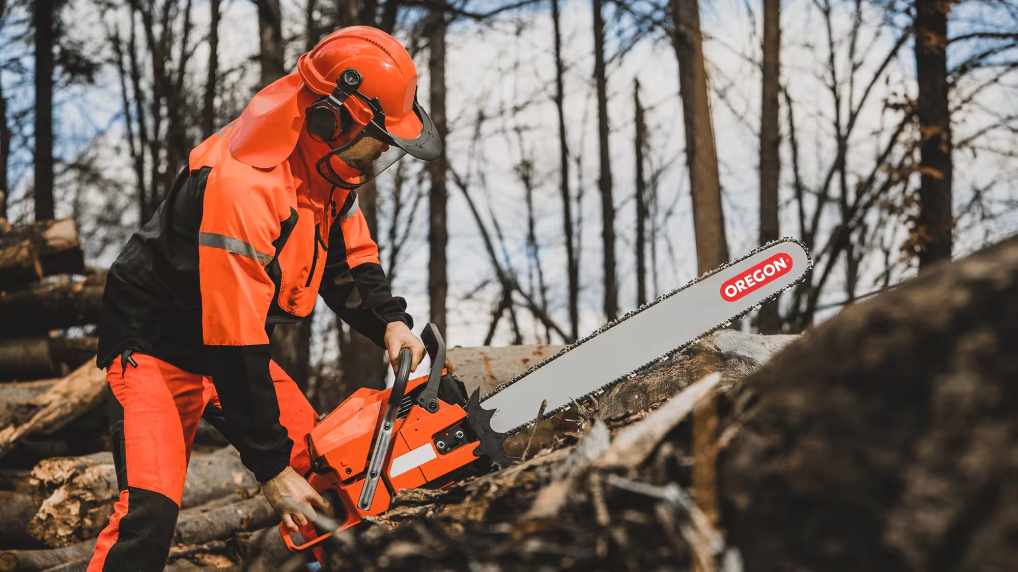 Man working with with Oregon branded chainsaw