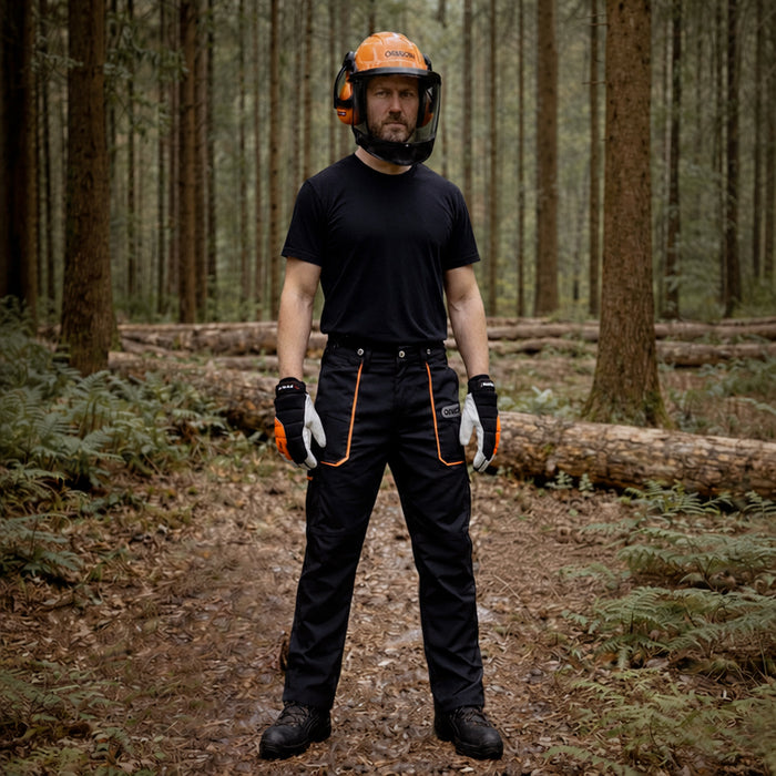 Man wearing Oregon safety gear including chainsaw trousers, boots, helmet & gloves.